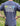 Person wearing a blue t-shirt with 'Great Outdoor Provision Co.' text and graphics outdoors.